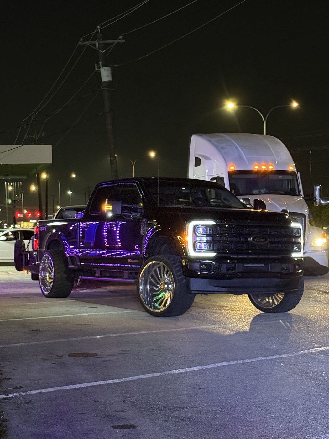 Black Ford Super Duty show truck on forged wheels with underglow