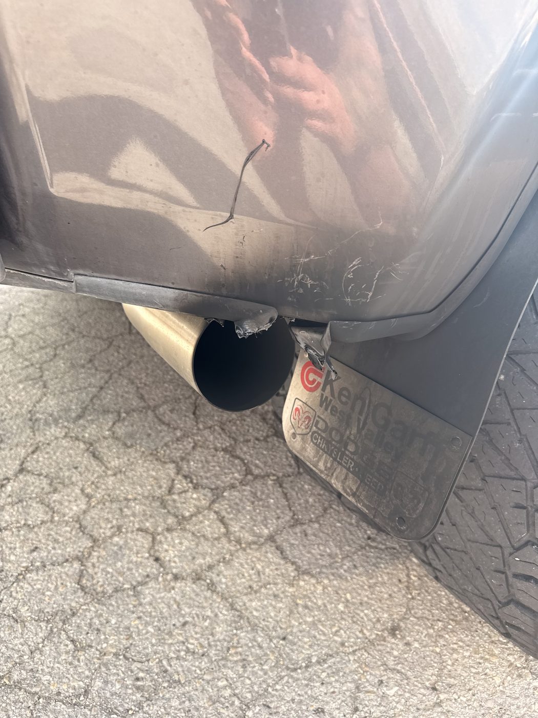 Exhaust exiting at the corner of the truck bed with visible melting and heat damage