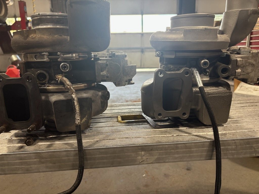 Installed turbo next to a factory turbo, showing different exhaust flanges
