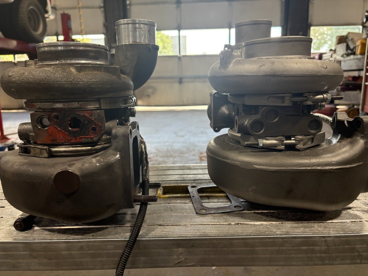 Side-by-side of the two turbos showing actuator and housing differences